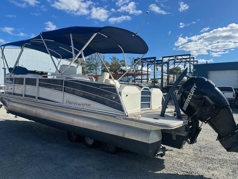 Slide: The Image of 2017 Berkshire 23SLX STS Entertainment pontoon boat with Mercury outboard motor. - 2