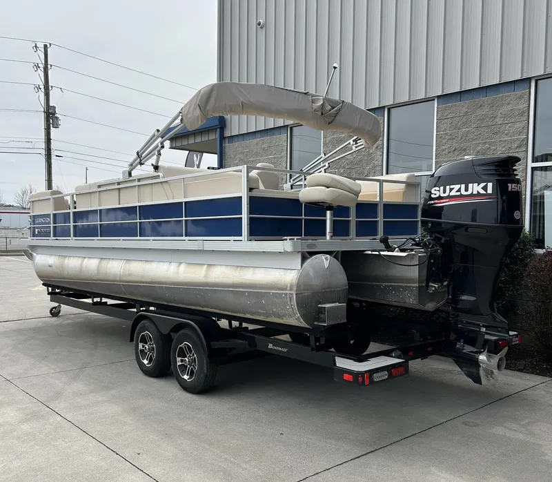 Slide: The Image of 2018 Lexington 325 Sport Tri-Toon boat with Suzuki engine on trailer. - 3