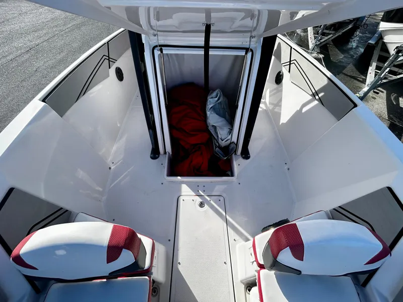 Slide: The Image of 2019 Scarab 255 Open ID boat interior with seating and storage compartment. - 10
