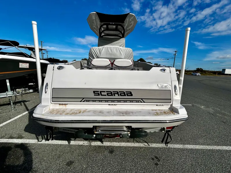 Slide: The Image of 2019 Scarab 255 Open ID boat, rear view in parking lot. - 12