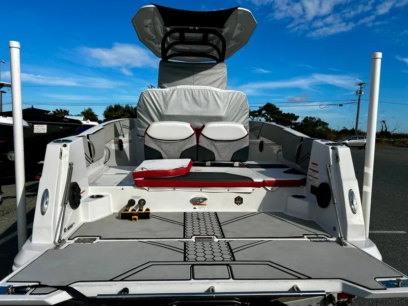 Slide: The Image of 2019 Scarab 255 Open ID boat, rear view, spacious deck, clear sky background. - 13
