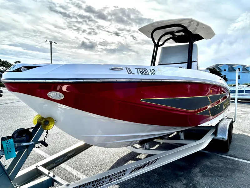 Slide: The Image of 2019 Scarab 255 Open ID boat on trailer, red and white design. - 2