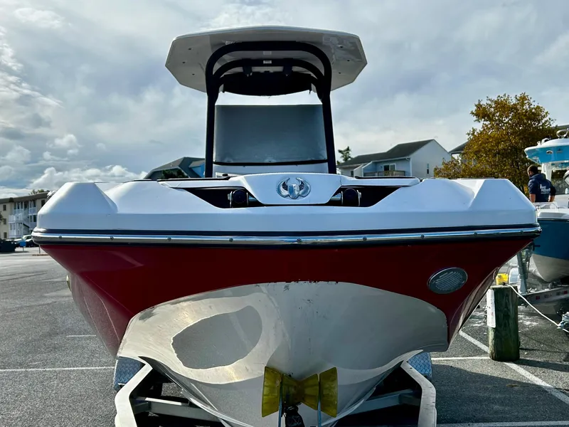 Slide: The Image of 2019 Scarab 255 Open ID boat, red and white, parked outdoors. - 3