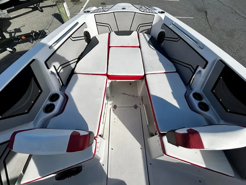 Slide: The Image of 2019 Scarab 255 Open ID boat interior with red-trimmed seating and cup holders. - 7