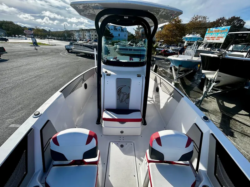 Slide: The Image of 2019 Scarab 255 Open ID boat with modern seating and sleek design in a marina. - 8