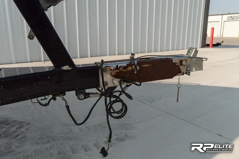 Slide: The Image of Rusty trailer hitch of 2000 Eliminator 220 Eagle XP with exposed wiring. - 14
