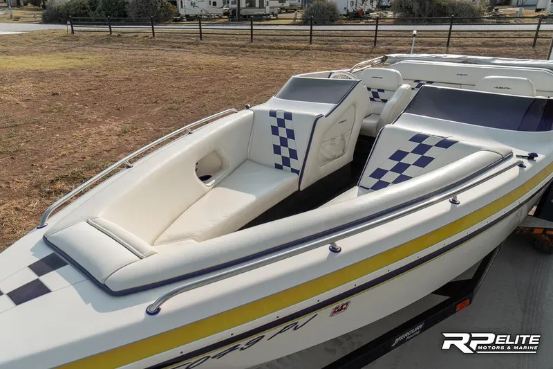 Slide: The Image of 2000 Eliminator 220 Eagle XP boat with checkered upholstery and sleek design. - 20
