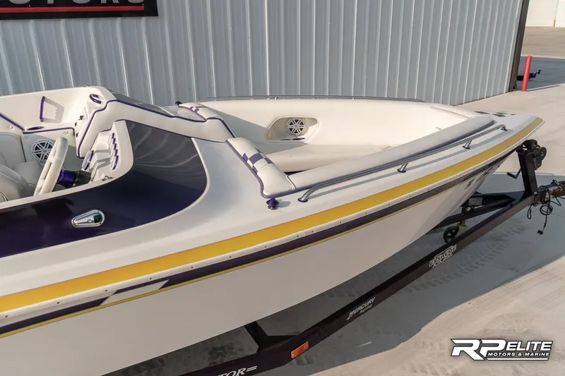 Slide: The Image of 2000 Eliminator 220 Eagle XP boat on trailer, white with yellow accents. - 24