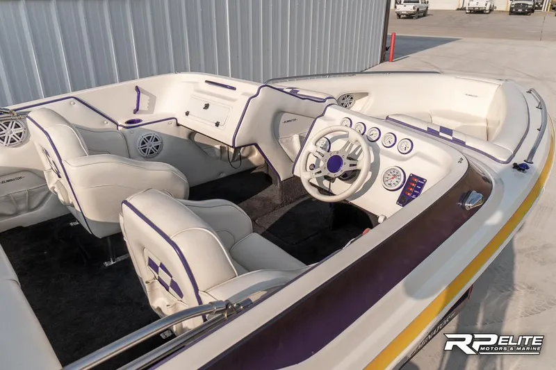 Slide: The Image of Interior of 2000 Eliminator 220 Eagle XP boat with white and purple seating. - 27