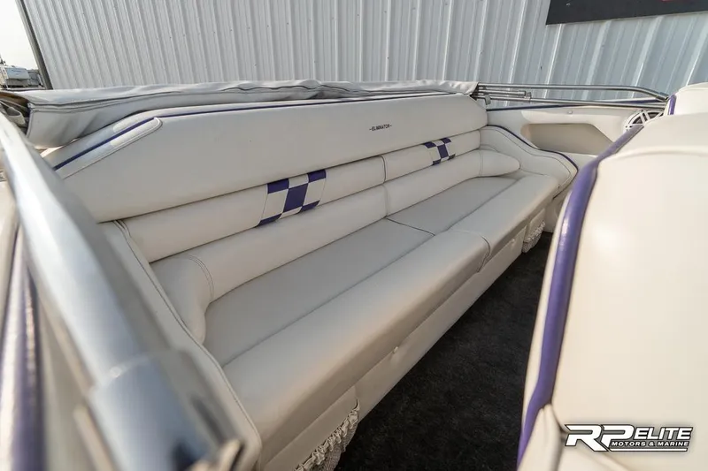 Slide: The Image of 2000 Eliminator 220 Eagle XP boat interior with white leather seating and checkered design. - 28