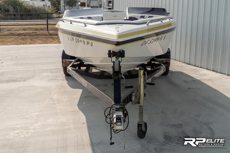Slide: The Image of 2000 Eliminator 220 Eagle XP boat on trailer, parked outdoors. - 3