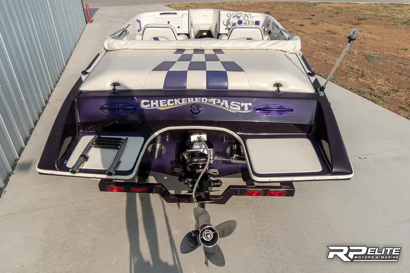 Slide: The Image of 2000 Eliminator 220 Eagle XP boat with checkered design and "Checkered Past" text on the back. - 31