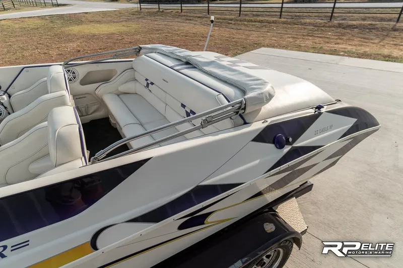 Slide: The Image of 2000 Eliminator 220 Eagle XP boat with white interior and sleek design. - 33