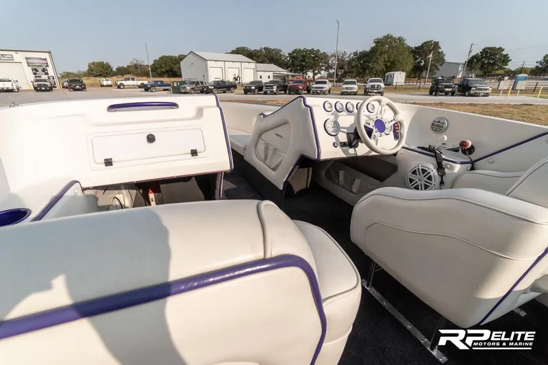 Slide: The Image of Interior of 2000 Eliminator 220 Eagle XP boat with white and purple seating. - 41