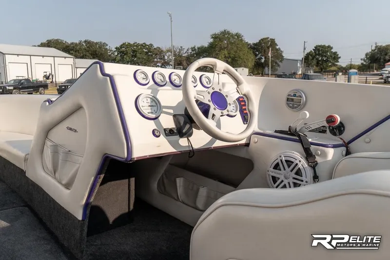Slide: The Image of 2000 Eliminator 220 Eagle XP boat interior with steering wheel and dashboard controls. - 42