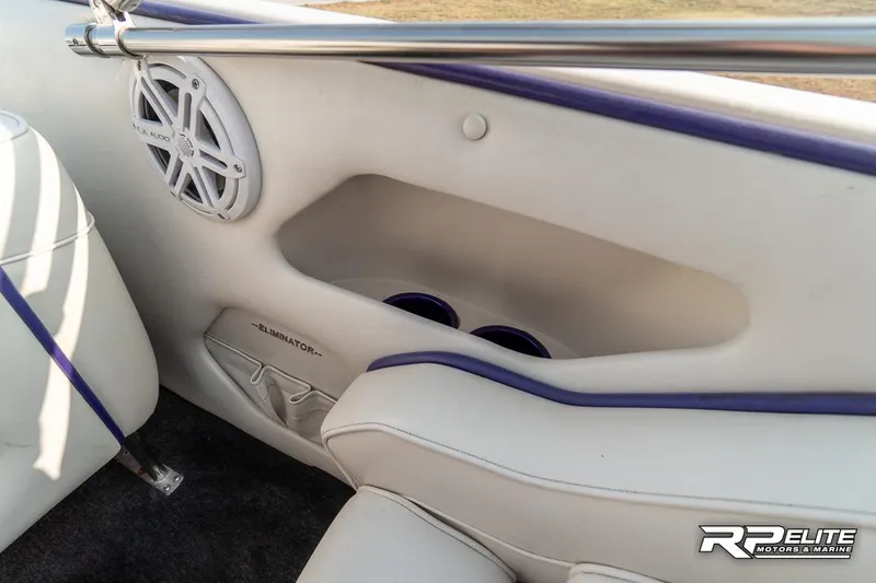 Slide: The Image of Interior of 2000 Eliminator 220 Eagle XP boat with white seating and speaker. - 44