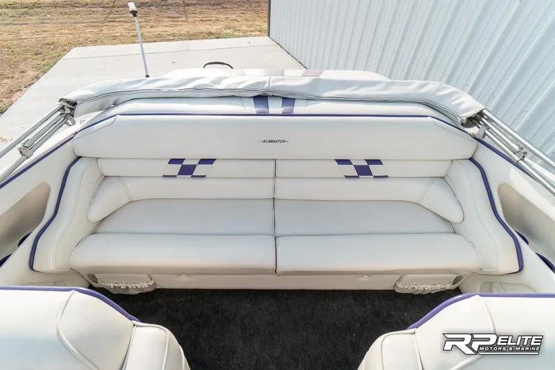 Slide: The Image of 2000 Eliminator 220 Eagle XP boat interior with white and blue seating. - 47