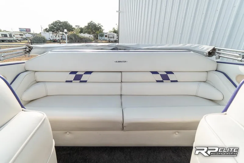 Slide: The Image of 2000 Eliminator 220 Eagle XP boat interior with white seating and blue accents. - 48