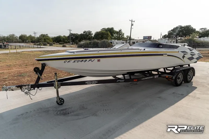 Slide: The Image of 2000 Eliminator 220 Eagle XP boat on trailer, parked outdoors. - 5