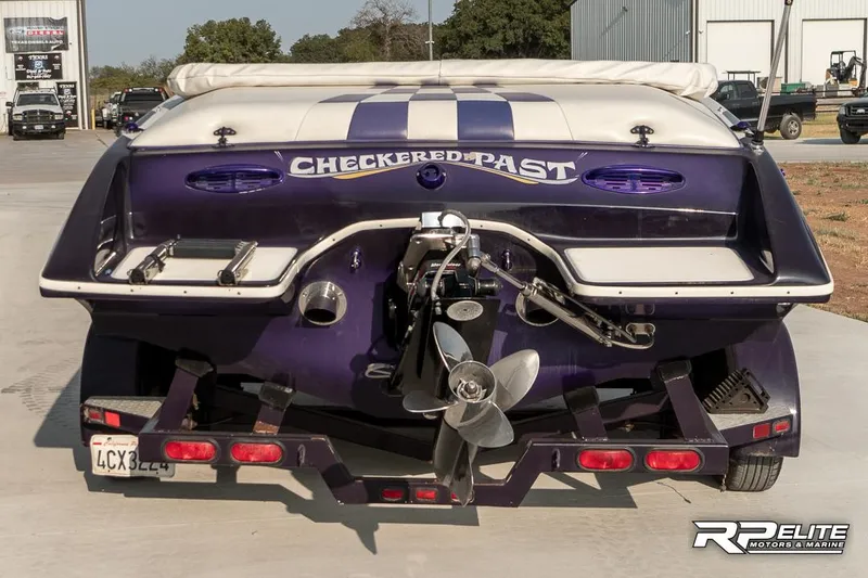 Slide: The Image of Rear view of 2000 Eliminator 220 Eagle XP boat with "Checkered Past" text. - 7