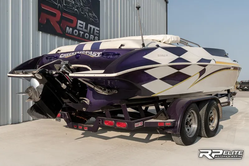 Slide: The Image of 2000 Eliminator 220 Eagle XP boat with custom graphics on trailer at RP Elite Motors. - 9