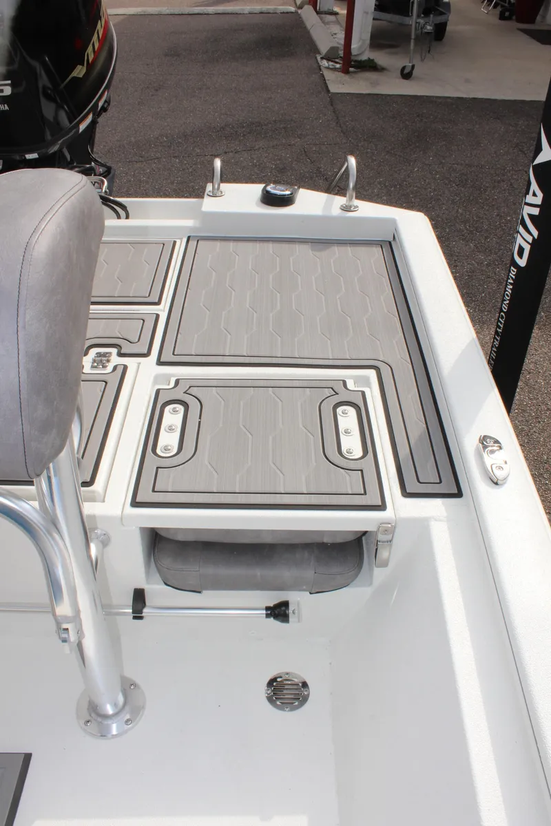 Slide: The Image of 2025 Avid 19 FSX boat deck with storage compartments and seating. - 12