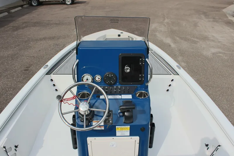 Slide: The Image of 2025 Avid 19 FSX boat console with steering wheel and controls. - 16