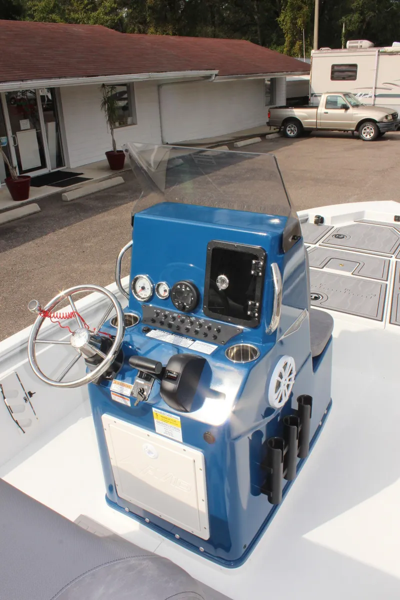 Slide: The Image of 2025 Avid 19 FSX boat console with steering wheel and gauges. - 19