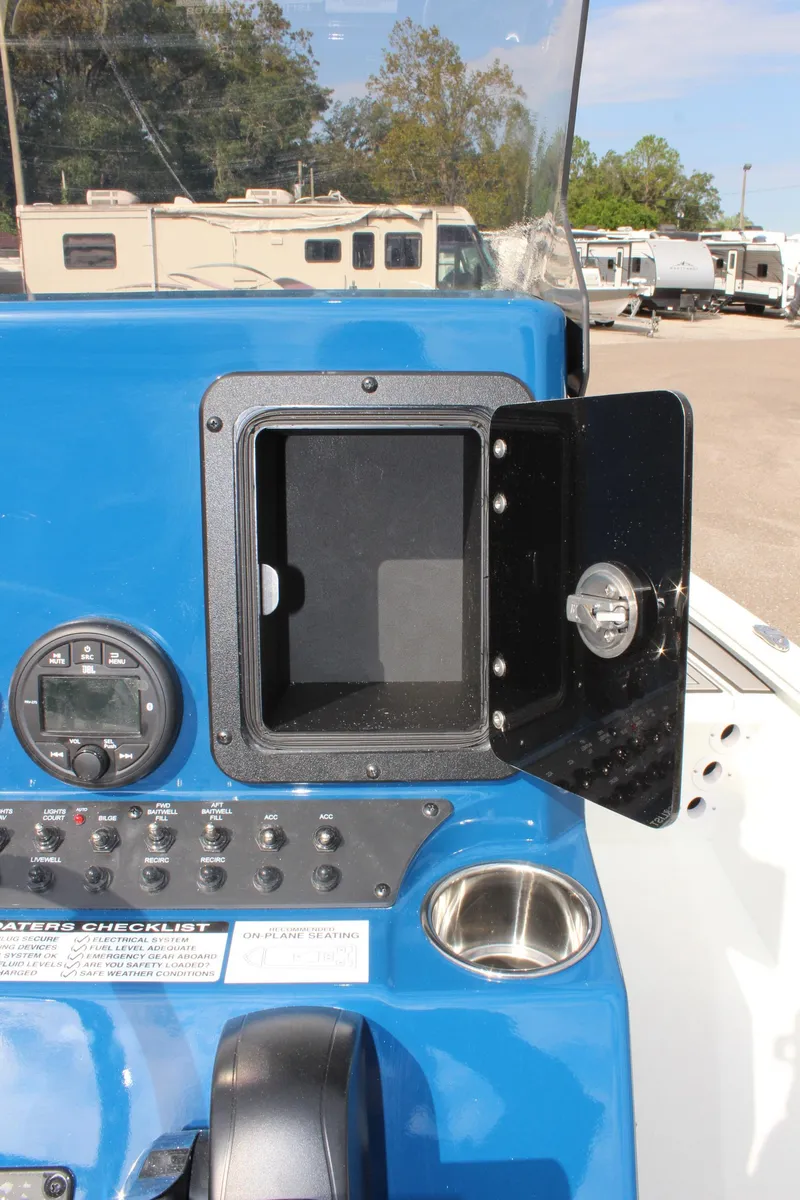 Slide: The Image of Avid 19 FSX 2025 boat dashboard with open storage compartment and control panel. - 23