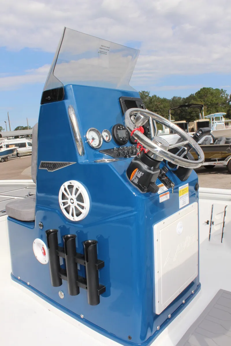 Slide: The Image of Avid 19 FSX 2025 boat console with steering wheel and gauges. - 24