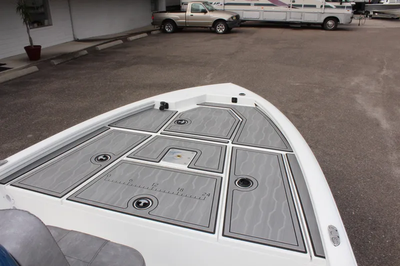 Slide: The Image of 2025 Avid 19 FSX boat deck with storage compartments and measuring ruler. - 26