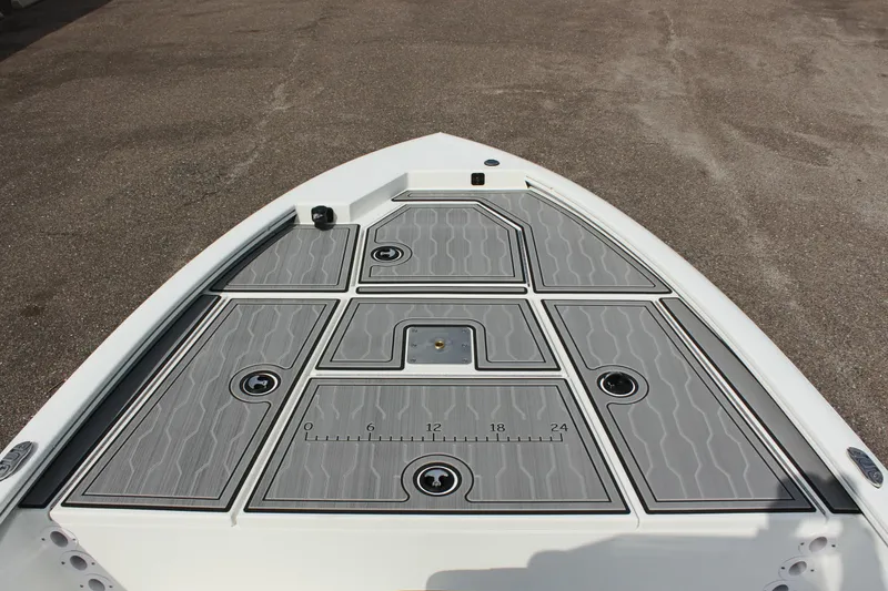 Slide: The Image of 2025 Avid 19 FSX boat deck with gray non-slip surface and storage compartments. - 28