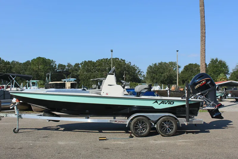 The Image of 2025 Avid 23 FSX boat on trailer in outdoor setting. - 1