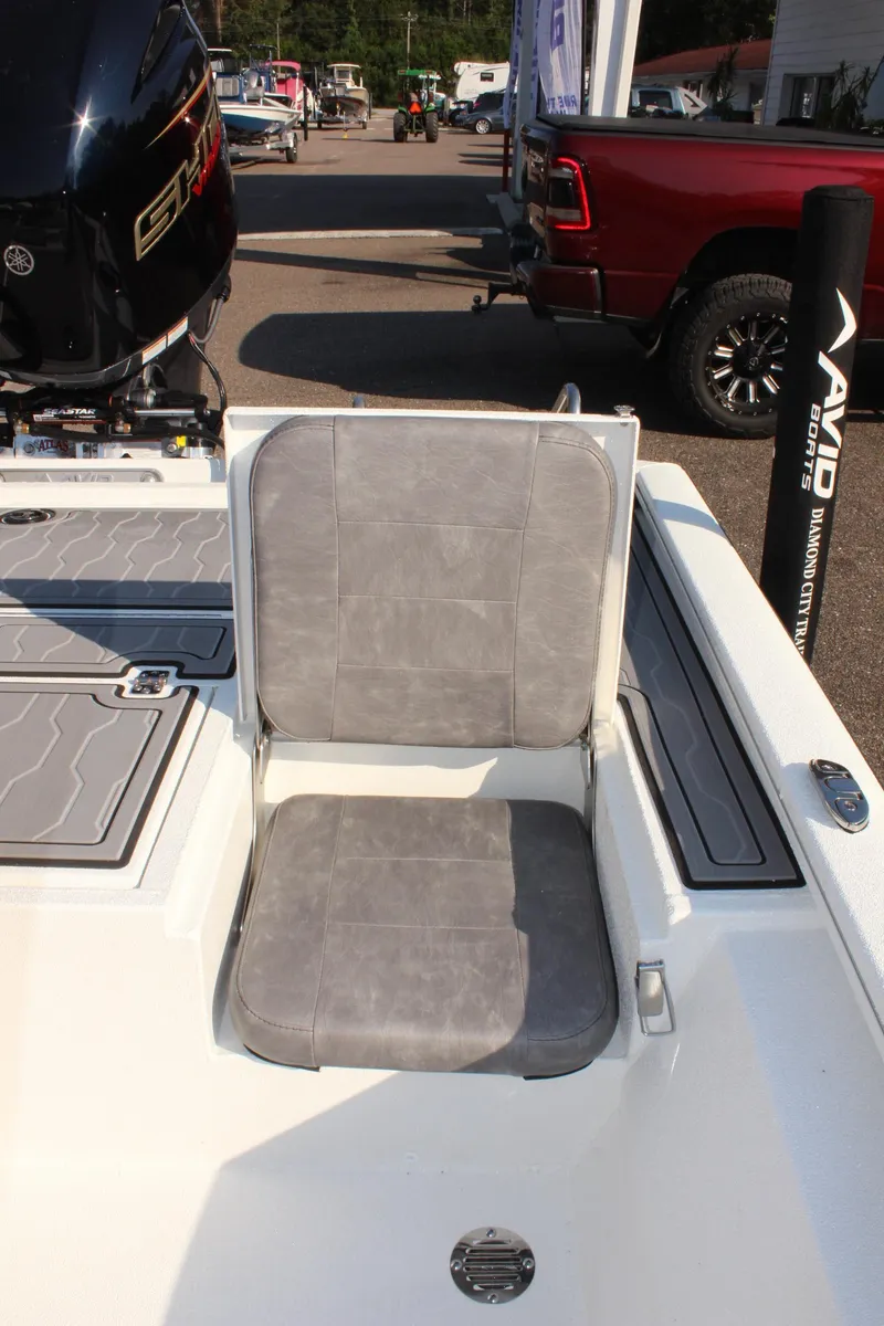 Slide: The Image of 2025 Avid 23 FSX boat with gray seating and motor detail. - 13