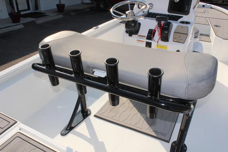 Slide: The Image of 2025 Avid 23 FSX boat interior with rod holders and steering console. - 17