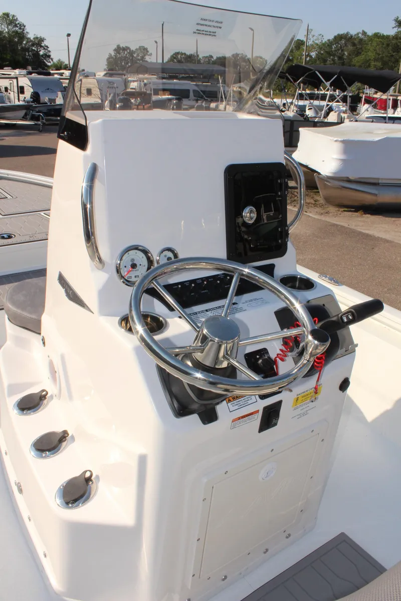 Slide: The Image of 2025 Avid 23 FSX boat console with steering wheel and gauges. - 19