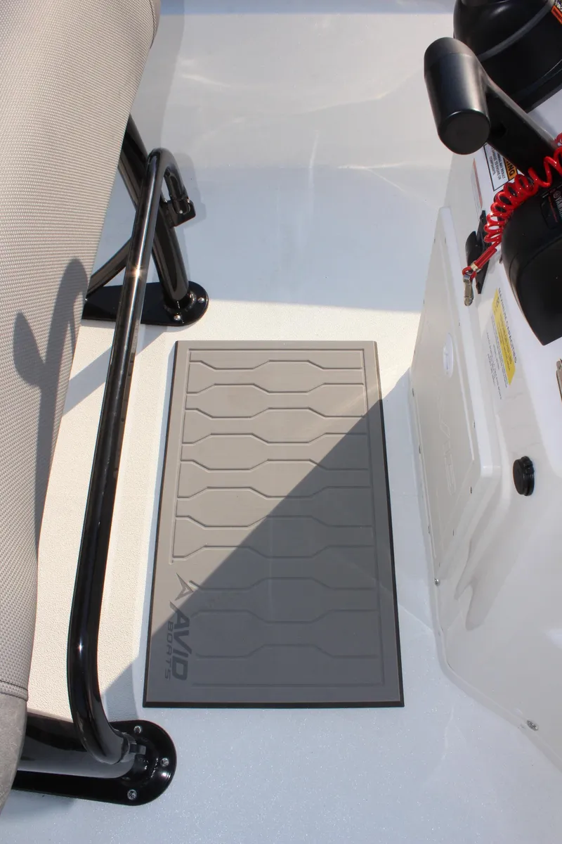 Slide: The Image of 2025 Avid 23 FSX boat interior with non-slip mat and seating. - 23