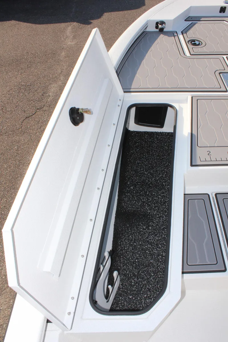 Slide: The Image of 2025 Avid 23 FSX boat storage compartment with open lid and interior view. - 27