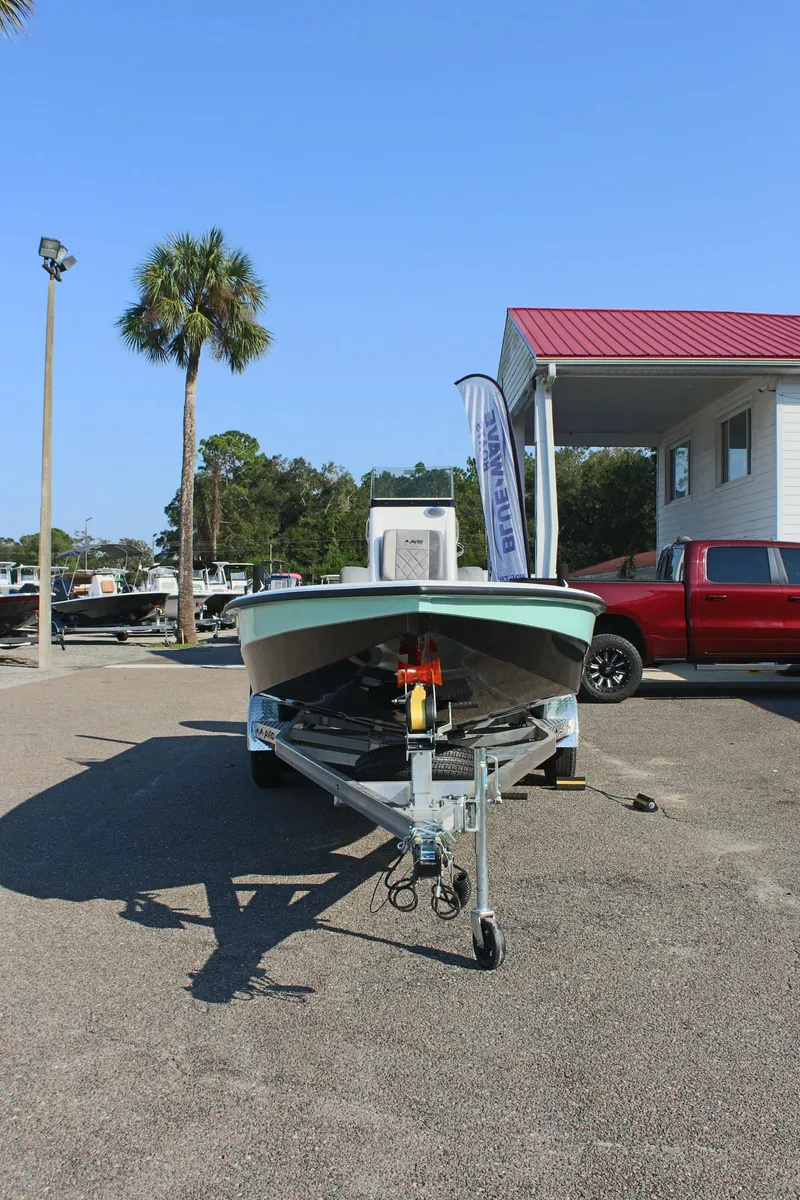 Slide: The Image of 2025 Avid 23 FSX boat on trailer in sunny outdoor setting. - 4