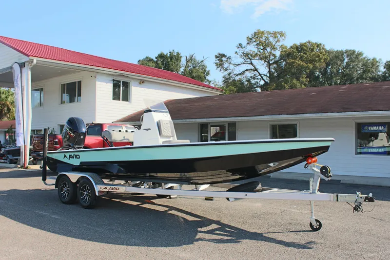 Slide: The Image of 2025 Avid 23 FSX boat on trailer outside dealership. - 5
