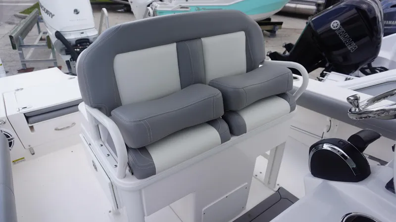 Slide: The Image of 2023 Everglades 253 CC boat seating with dual cushioned seats and steering console. - 10