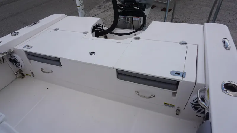 Slide: The Image of 2023 Everglades 253 CC boat interior with storage compartments and speakers. - 12