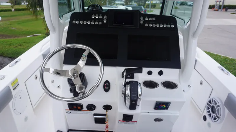 Slide: The Image of 2023 Everglades 253 CC boat dashboard with steering wheel and control panel. - 15