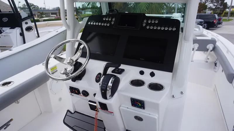 Slide: The Image of 2023 Everglades 253 CC boat helm with dual displays and steering wheel. - 17