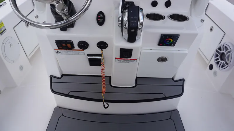 Slide: The Image of 2023 Everglades 253 CC boat console with steering wheel and controls. - 18