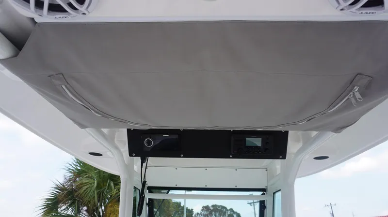 Slide: The Image of 2023 Everglades 253 CC boat interior with storage and audio system. - 19