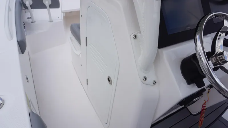 Slide: The Image of 2023 Everglades 253 CC boat interior with steering wheel and seating area. - 20