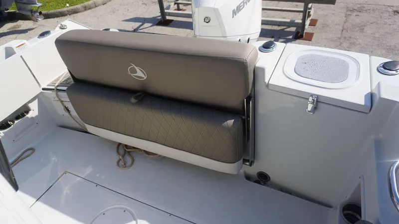 Slide: The Image of 2023 Finseeker 210 FC boat interior with cushioned seating and storage compartments. - 10