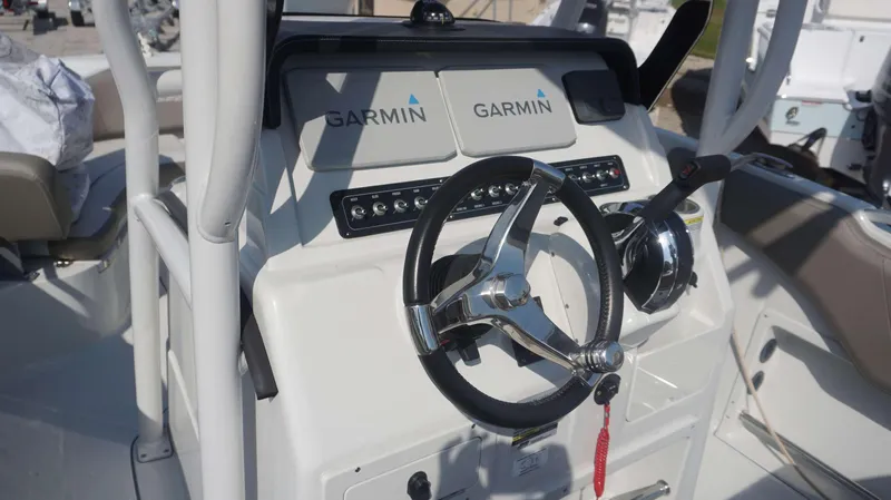 Slide: The Image of 2023 Finseeker 210 FC boat console with Garmin navigation system and steering wheel. - 13