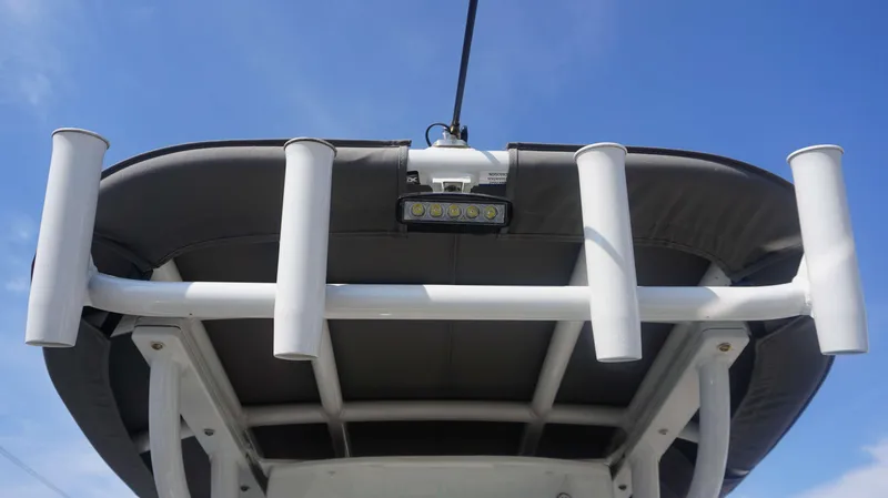 Slide: The Image of 2023 Finseeker 210 FC boat canopy with rod holders against blue sky. - 16